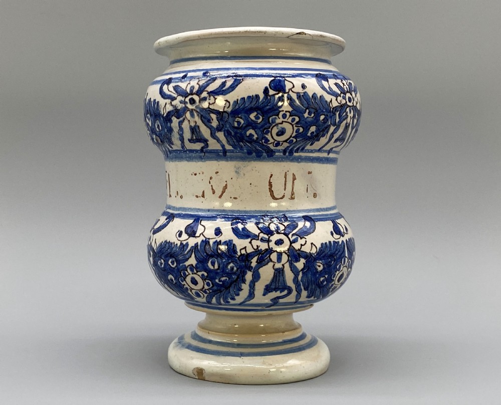An 18th-century Italian majolica albarello pharmacy jar featuring a waisted silhouette with hand-painted blue floral patterns and central apothecary inscription. View III