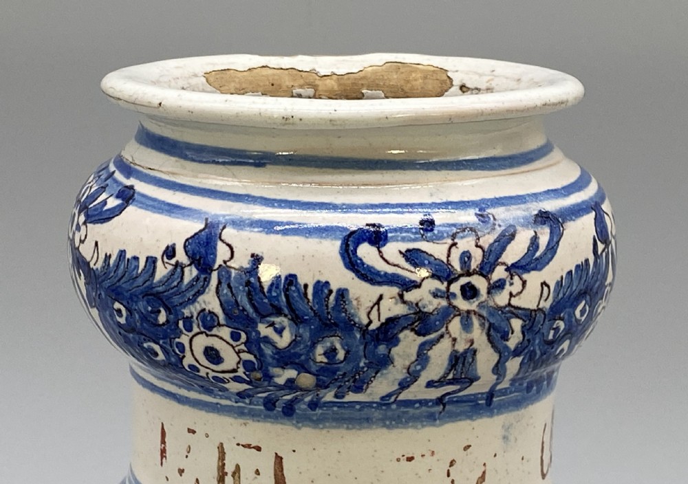 An 18th-century Italian majolica albarello pharmacy jar featuring a waisted silhouette with hand-painted blue floral patterns and central apothecary inscription. View VI