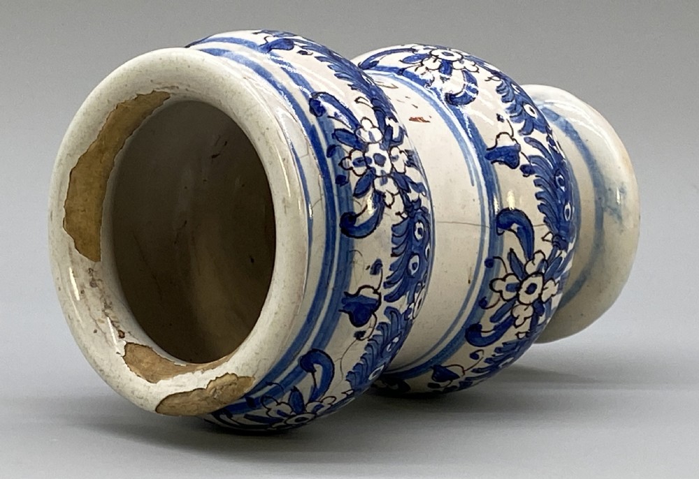 An 18th-century Italian majolica albarello pharmacy jar featuring a waisted silhouette with hand-painted blue floral patterns and central apothecary inscription. View XII
