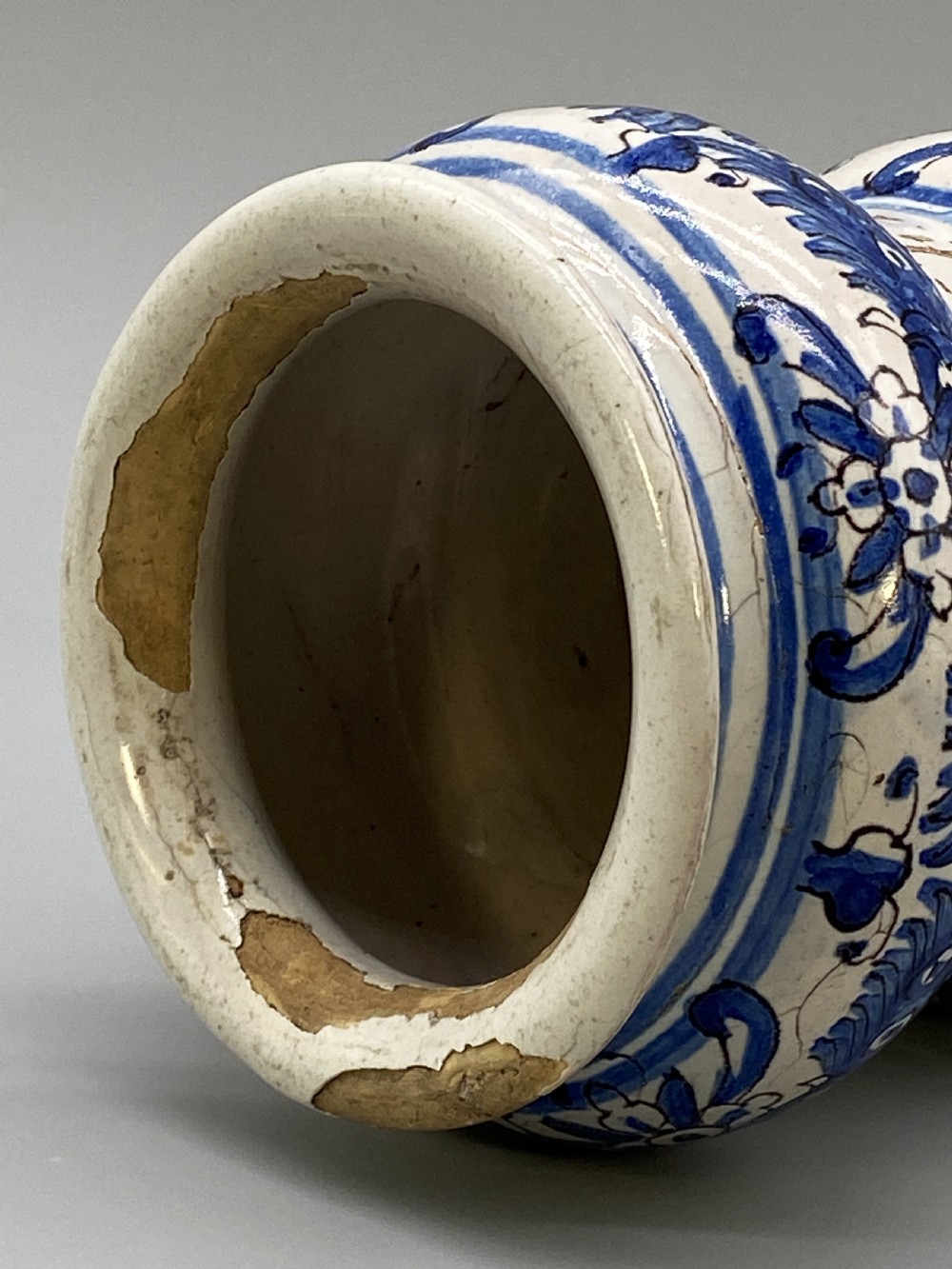 An 18th-century Italian majolica albarello pharmacy jar featuring a waisted silhouette with hand-painted blue floral patterns and central apothecary inscription. View XIII