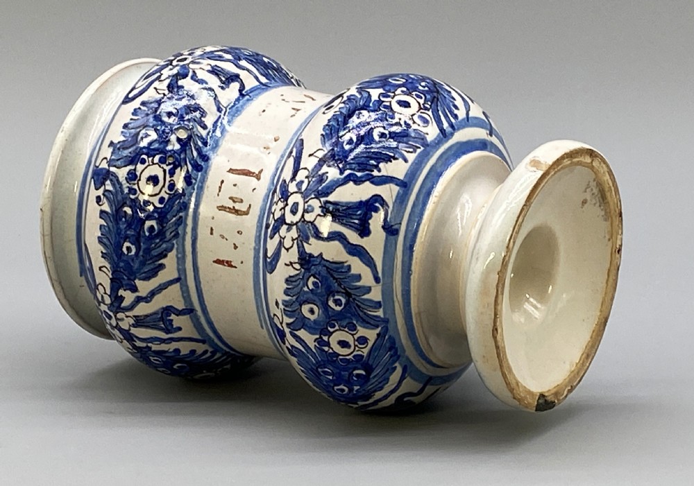An 18th-century Italian majolica albarello pharmacy jar featuring a waisted silhouette with hand-painted blue floral patterns and central apothecary inscription. View XIV