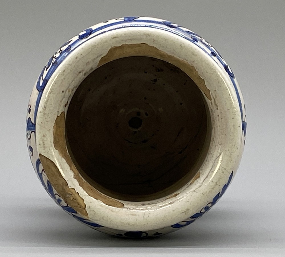 An 18th-century Italian majolica albarello pharmacy jar featuring a waisted silhouette with hand-painted blue floral patterns and central apothecary inscription. View XV