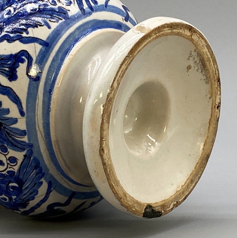 An 18th-century Italian majolica albarello pharmacy jar featuring a waisted silhouette with hand-painted blue floral patterns and central apothecary inscription. View XVII