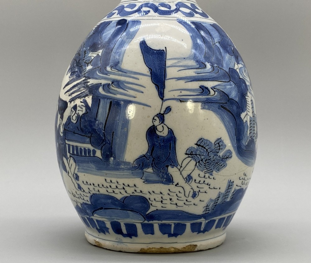 A 17th-century Dutch Delftware ceramic jug featuring hand-painted blue chinoiserie scenes on an opaque white tin glaze with a curved handle. View XII
