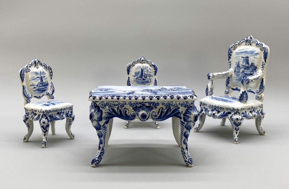 A four-piece set of miniature ceramic furniture decorated with hand-painted blue and white Dutch landscapes and windmill scenes. View IV