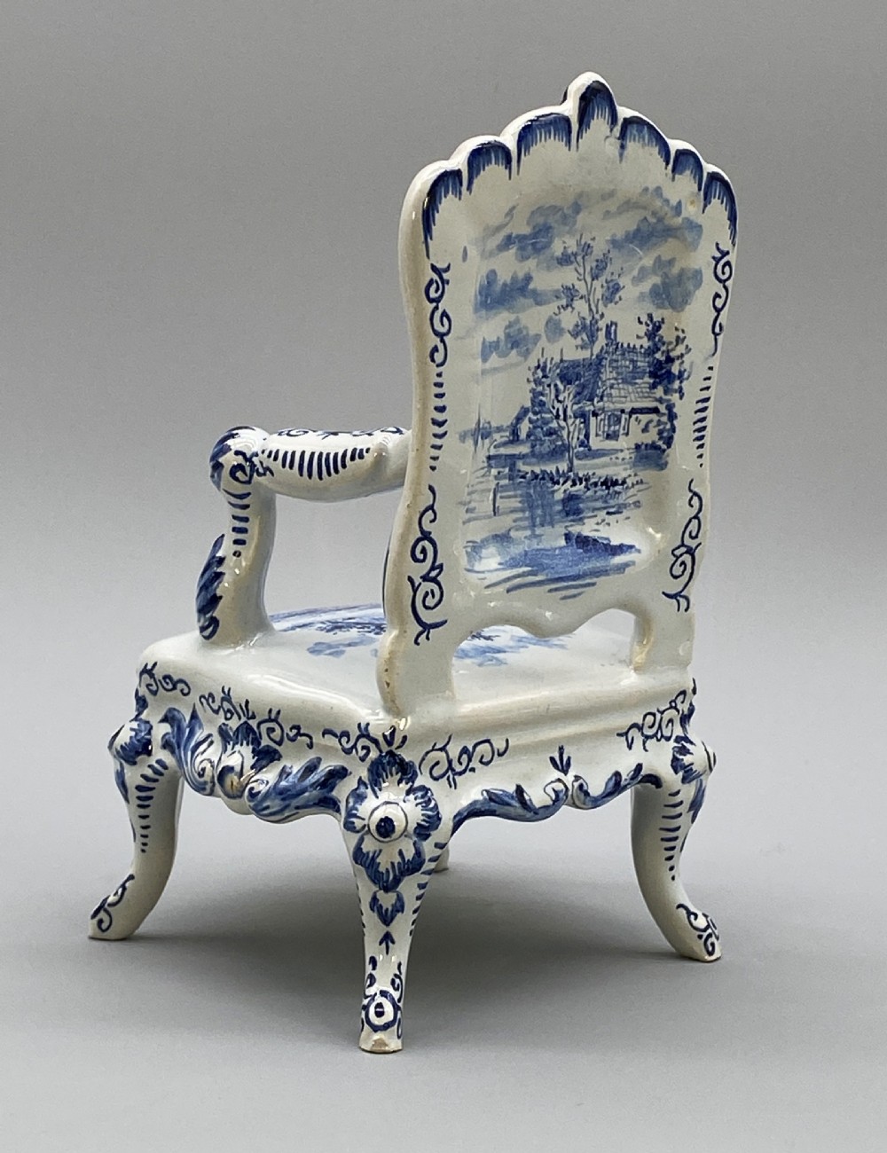 A four-piece set of miniature ceramic furniture decorated with hand-painted blue and white Dutch landscapes and windmill scenes. View VII