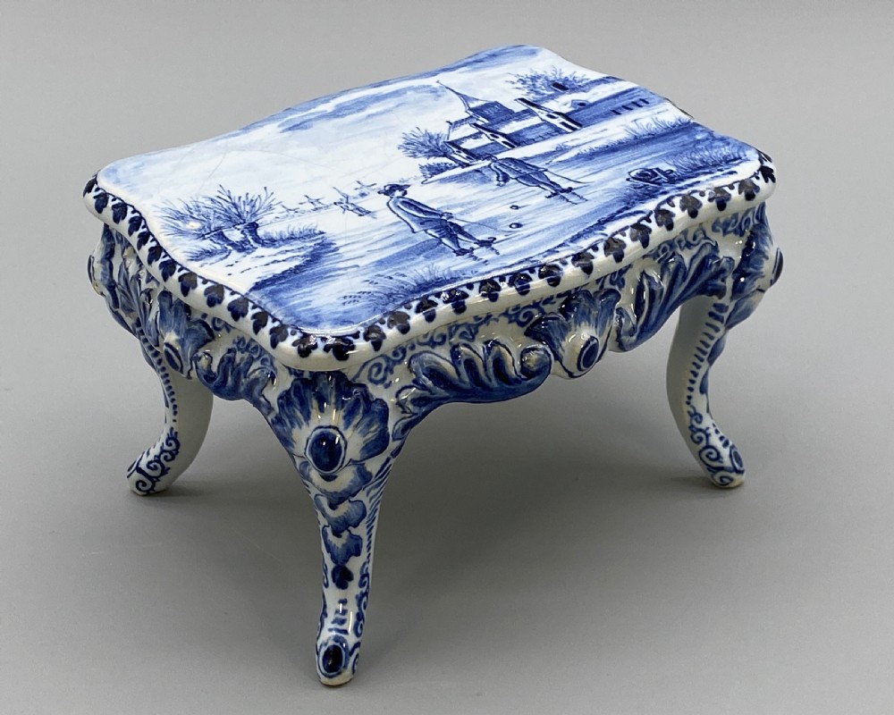 A four-piece set of miniature ceramic furniture decorated with hand-painted blue and white Dutch landscapes and windmill scenes. View IX