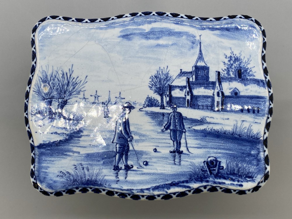 A four-piece set of miniature ceramic furniture decorated with hand-painted blue and white Dutch landscapes and windmill scenes. View XI