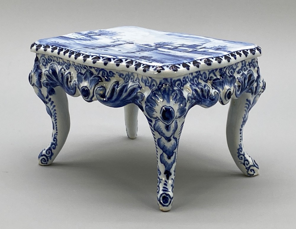 A four-piece set of miniature ceramic furniture decorated with hand-painted blue and white Dutch landscapes and windmill scenes. View XII
