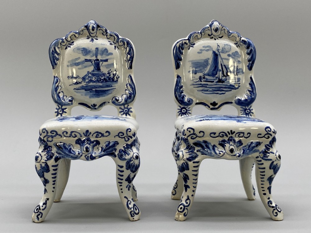 A four-piece set of miniature ceramic furniture decorated with hand-painted blue and white Dutch landscapes and windmill scenes. View XIV