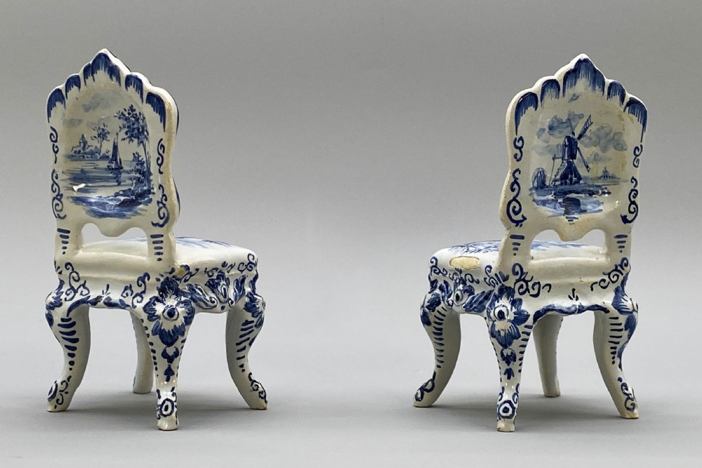 A four-piece set of miniature ceramic furniture decorated with hand-painted blue and white Dutch landscapes and windmill scenes. View XV