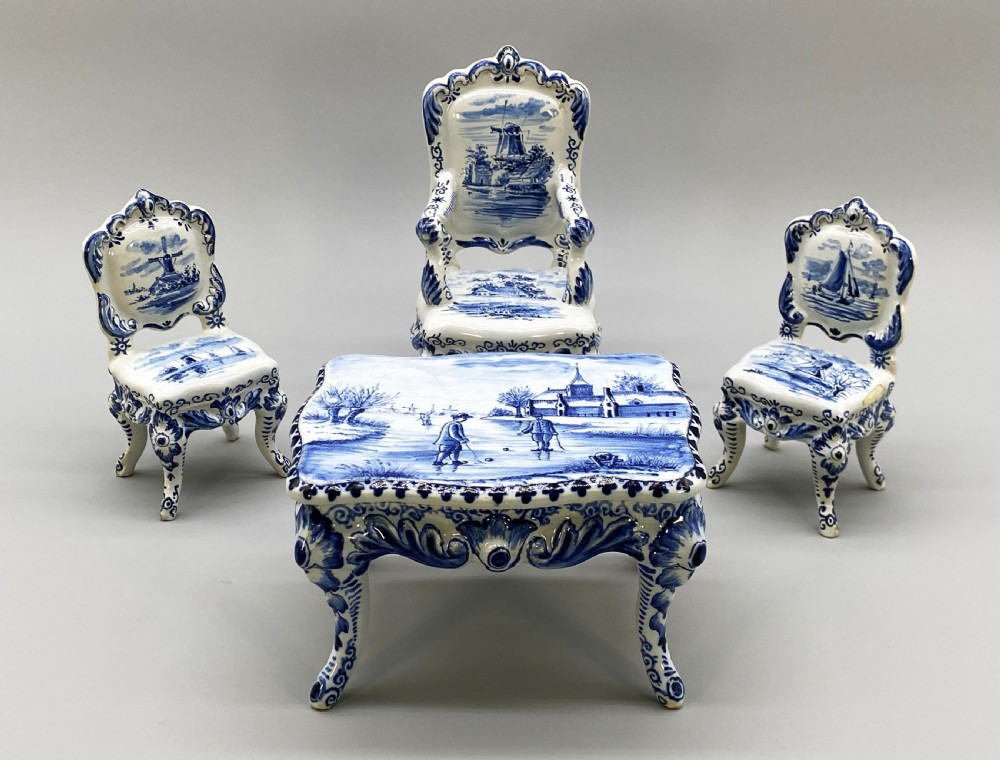 A four-piece set of miniature ceramic furniture decorated with hand-painted blue and white Dutch landscapes and windmill scenes. View XVI