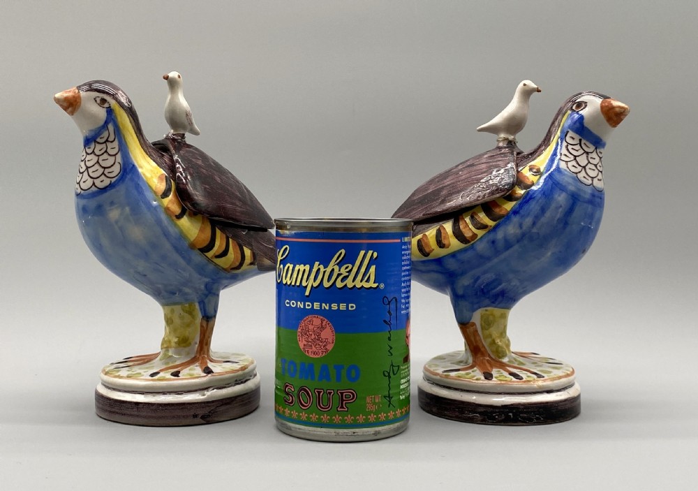 A pair of 18th-century Spanish tin-glazed faience tureens fashioned as partridges with hand-painted blue, yellow, and brown plumage and small bird finials on their removable covers. View III