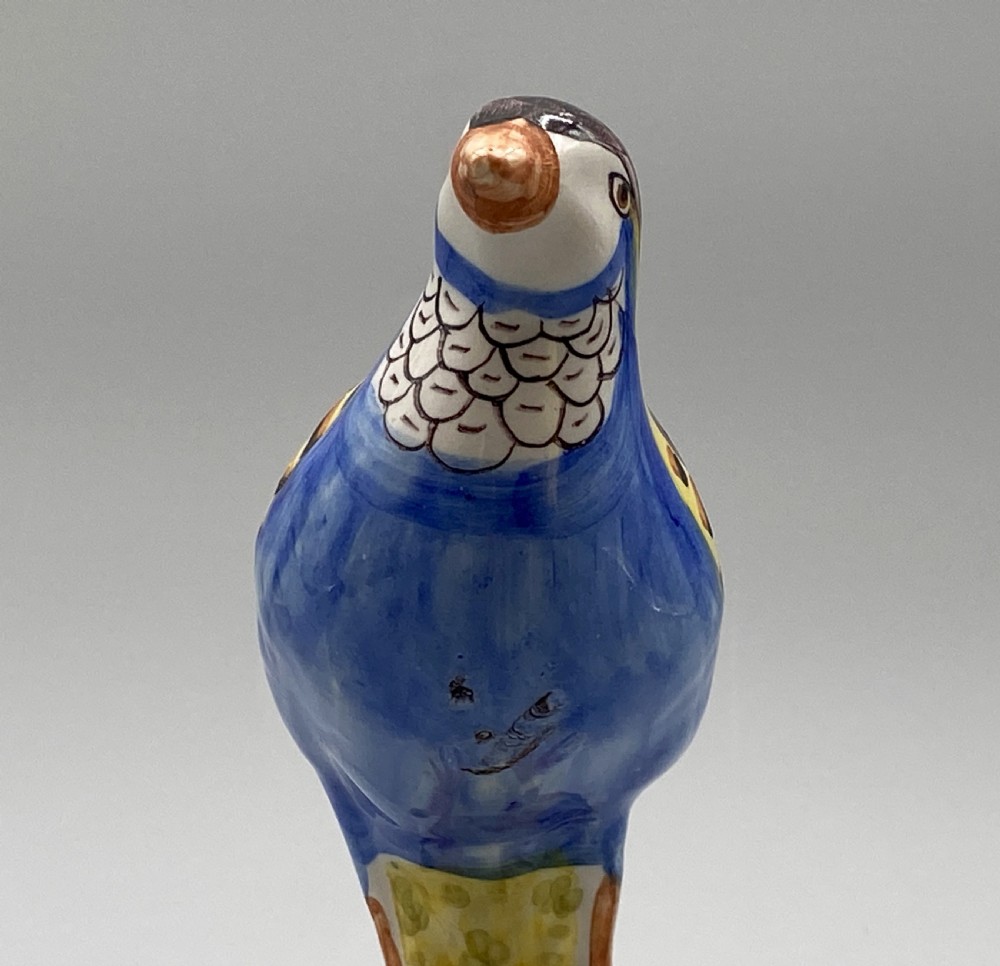 A pair of 18th-century Spanish tin-glazed faience tureens fashioned as partridges with hand-painted blue, yellow, and brown plumage and small bird finials on their removable covers. View XV