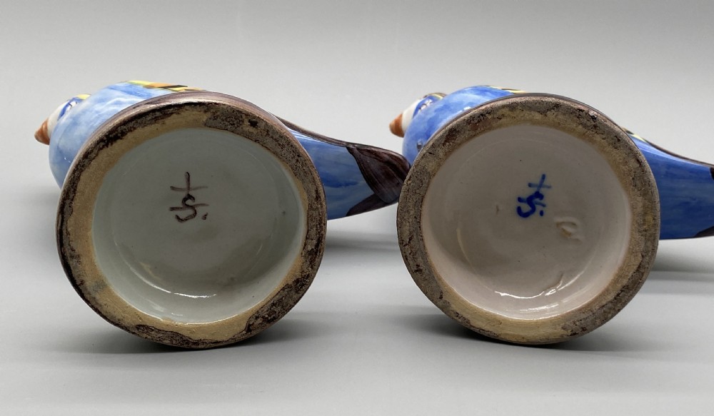 A pair of 18th-century Spanish tin-glazed faience tureens fashioned as partridges with hand-painted blue, yellow, and brown plumage and small bird finials on their removable covers. View XXI
