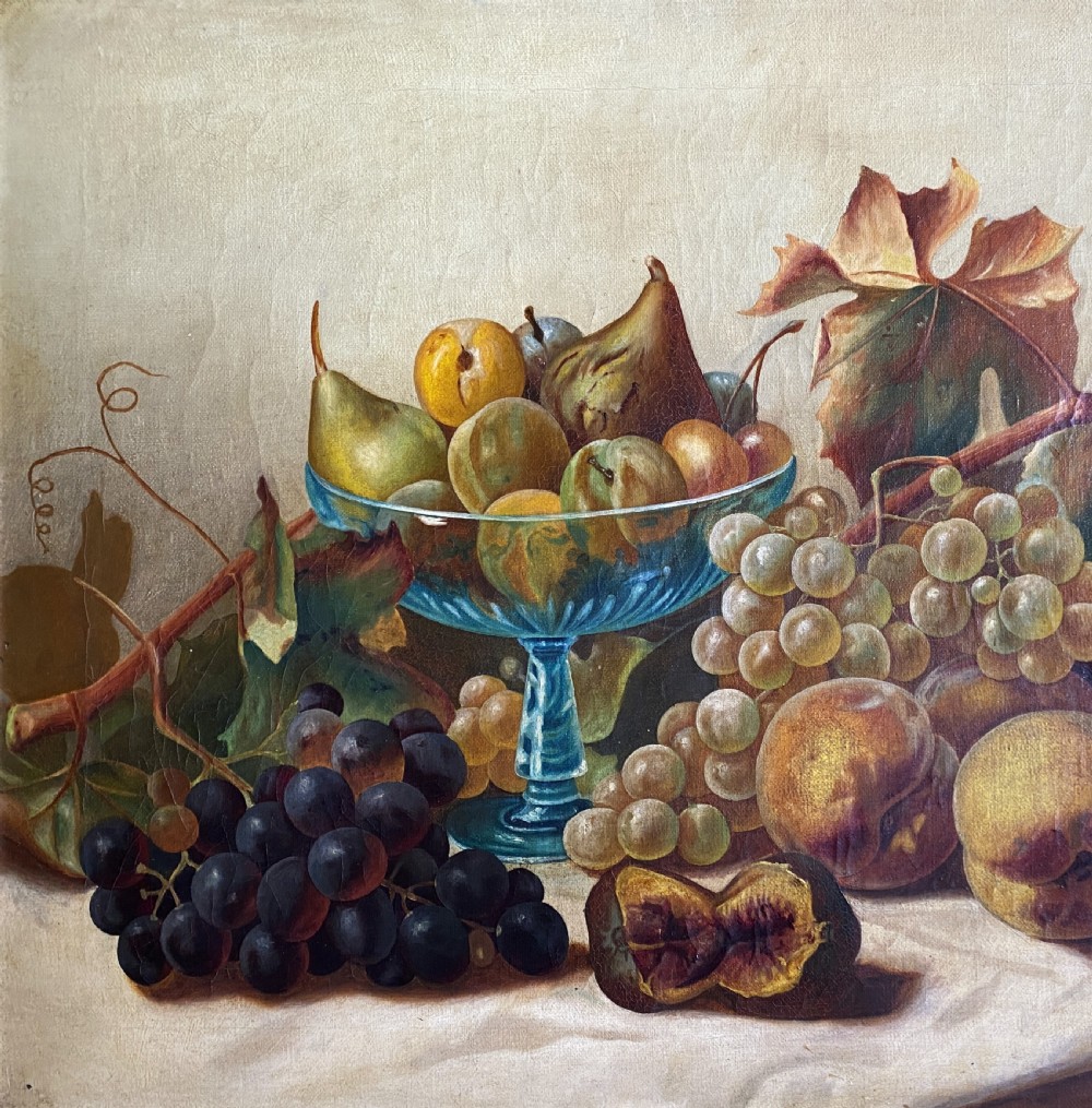 An oil painting depicting a still life composition of grapes, pears, peaches, and figs arranged on a draped cloth with a blue glass pedestal dish, enclosed in a moulded gilt frame. View III