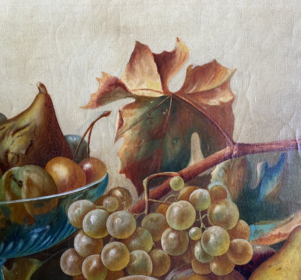 An oil painting depicting a still life composition of grapes, pears, peaches, and figs arranged on a draped cloth with a blue glass pedestal dish, enclosed in a moulded gilt frame. View VII