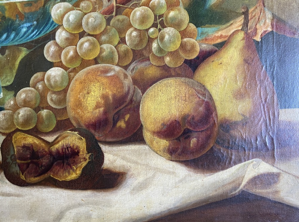 An oil painting depicting a still life composition of grapes, pears, peaches, and figs arranged on a draped cloth with a blue glass pedestal dish, enclosed in a moulded gilt frame. View VIII