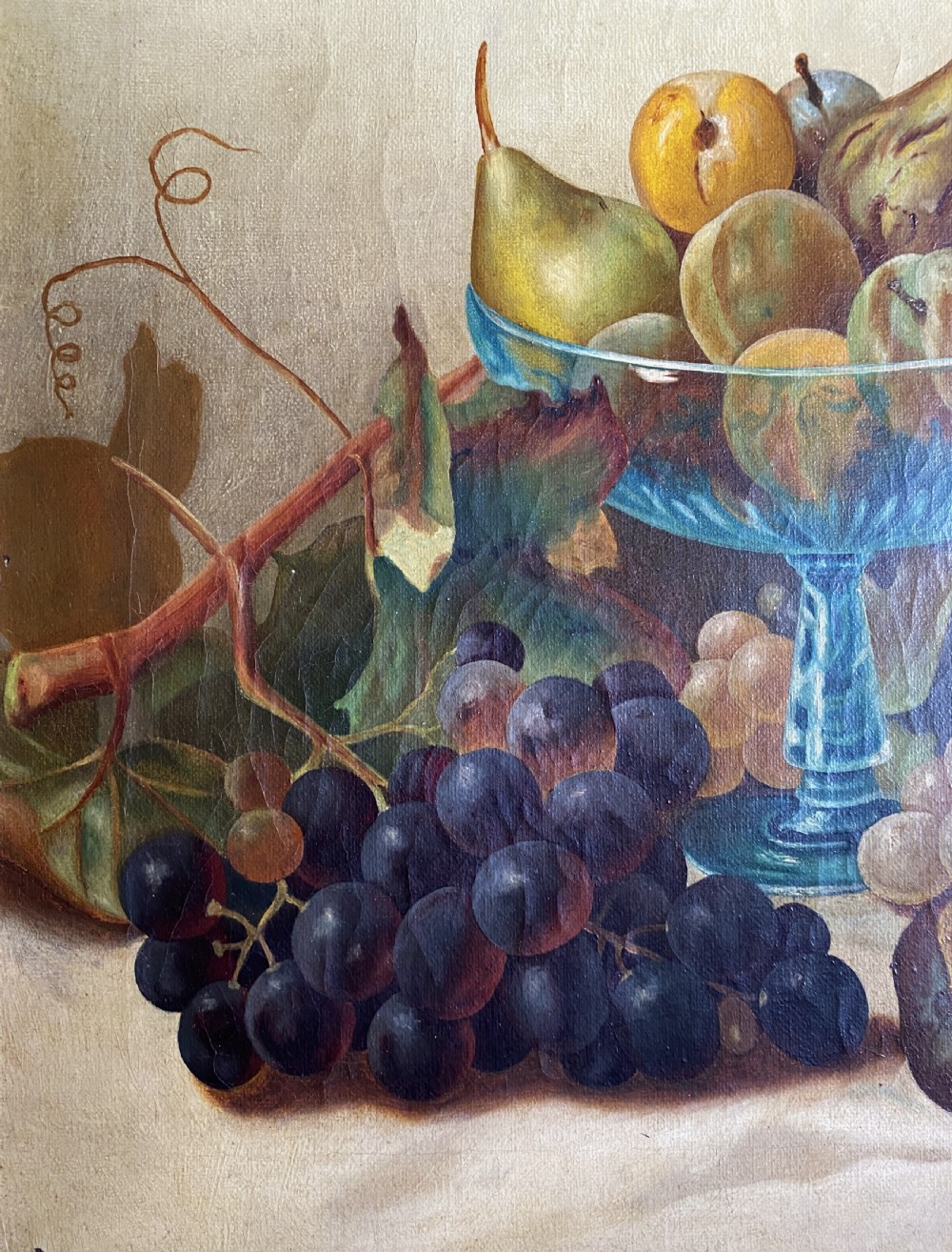 An oil painting depicting a still life composition of grapes, pears, peaches, and figs arranged on a draped cloth with a blue glass pedestal dish, enclosed in a moulded gilt frame. View IX