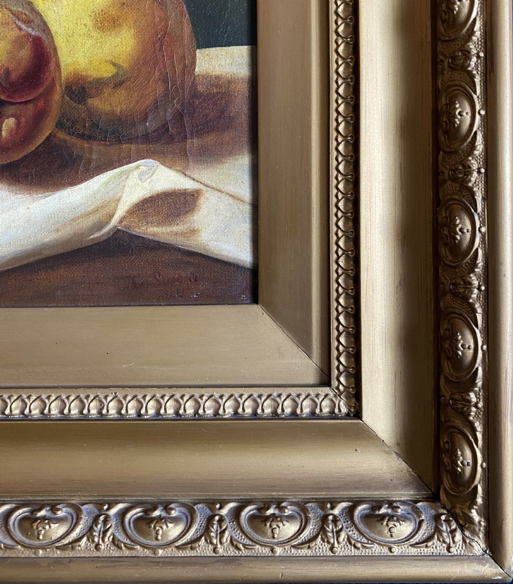 An oil painting depicting a still life composition of grapes, pears, peaches, and figs arranged on a draped cloth with a blue glass pedestal dish, enclosed in a moulded gilt frame. View XI