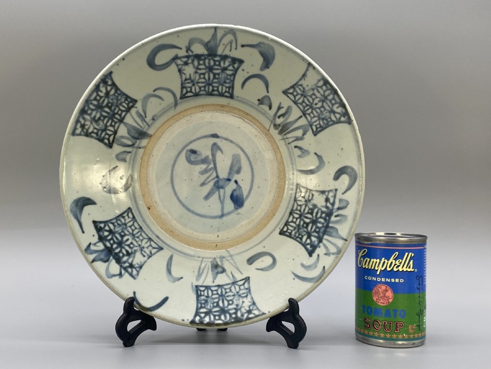A circular 16th-century Chinese Swatow blue and white porcelain charger dish decorated with underglaze cobalt painted panels and central calligraphic motif. View II
