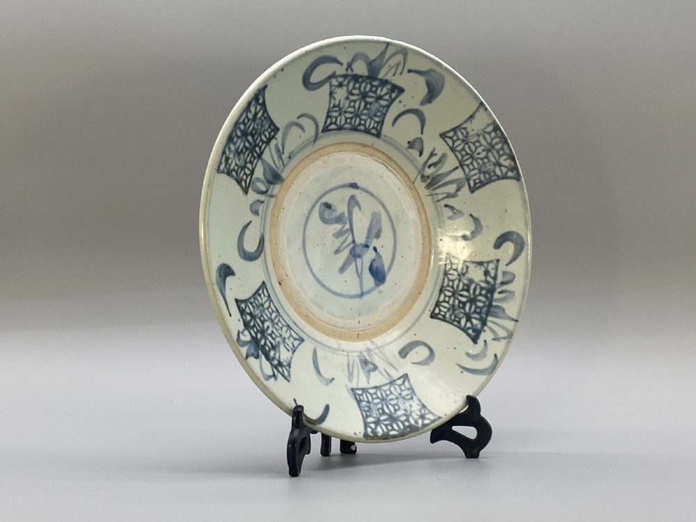 A circular 16th-century Chinese Swatow blue and white porcelain charger dish decorated with underglaze cobalt painted panels and central calligraphic motif. View III