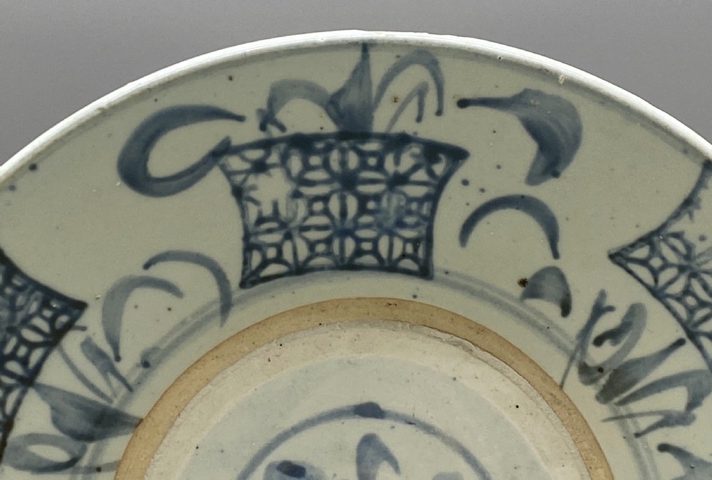 A circular 16th-century Chinese Swatow blue and white porcelain charger dish decorated with underglaze cobalt painted panels and central calligraphic motif. View V