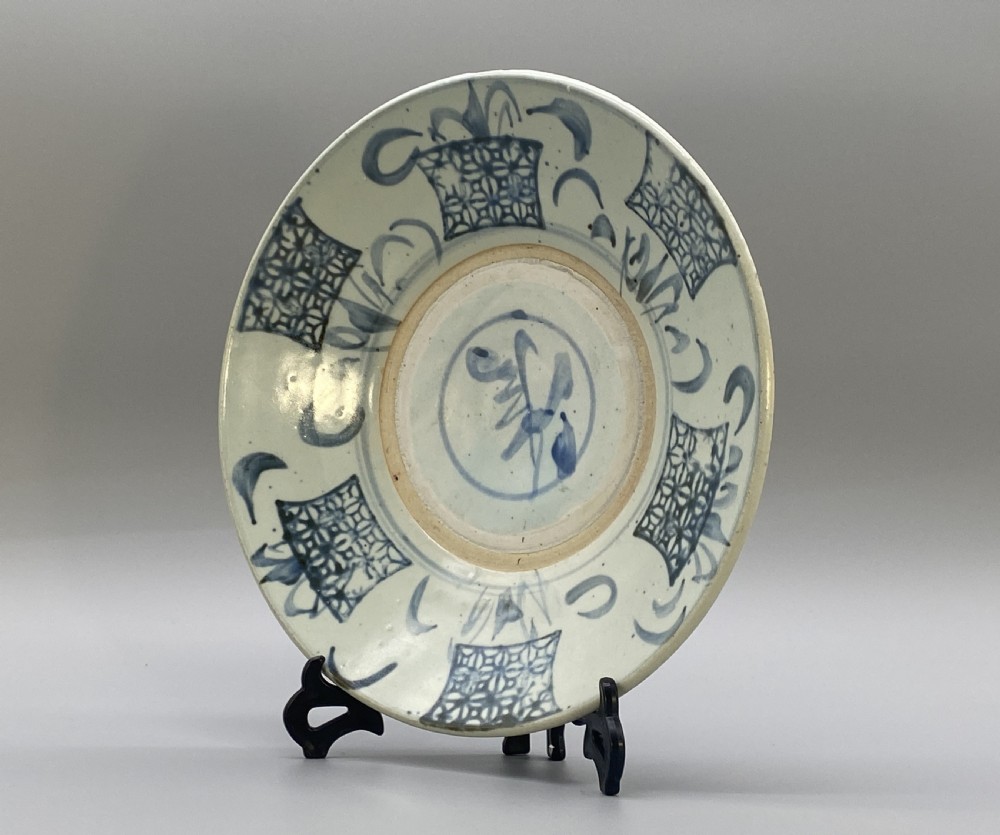 A circular 16th-century Chinese Swatow blue and white porcelain charger dish decorated with underglaze cobalt painted panels and central calligraphic motif. View VI