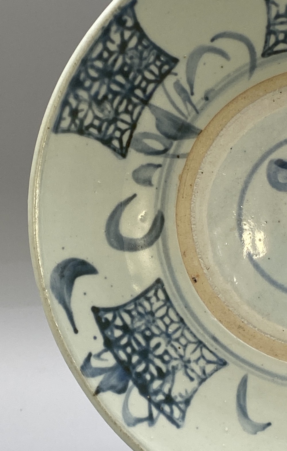 A circular 16th-century Chinese Swatow blue and white porcelain charger dish decorated with underglaze cobalt painted panels and central calligraphic motif. View VII