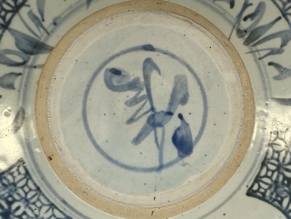 A circular 16th-century Chinese Swatow blue and white porcelain charger dish decorated with underglaze cobalt painted panels and central calligraphic motif. View X