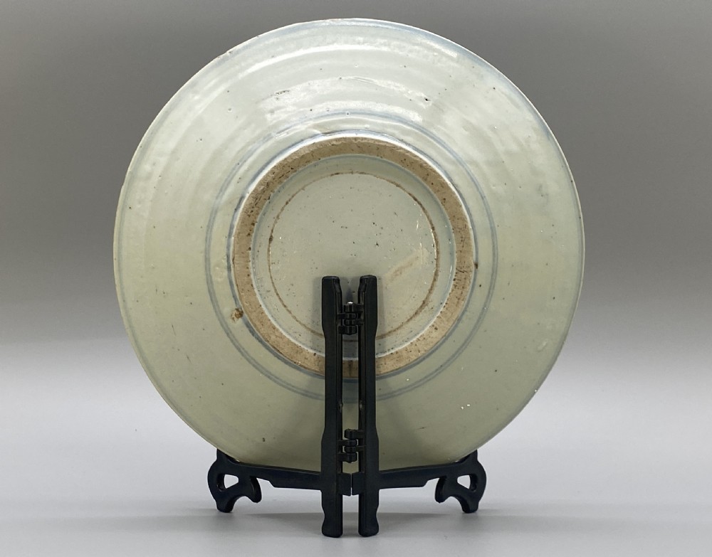 A circular 16th-century Chinese Swatow blue and white porcelain charger dish decorated with underglaze cobalt painted panels and central calligraphic motif. View XI