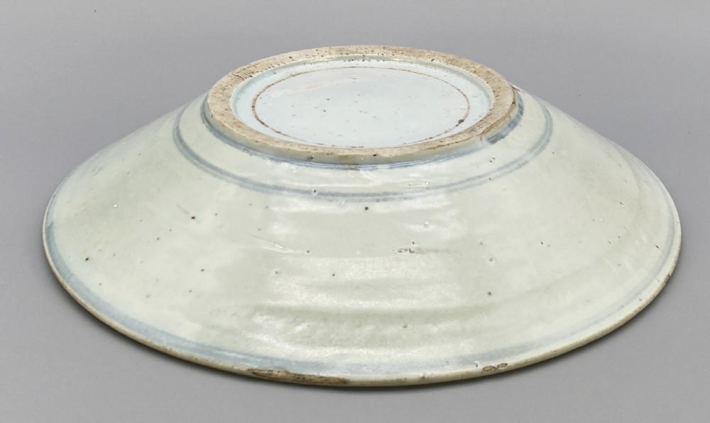 A circular 16th-century Chinese Swatow blue and white porcelain charger dish decorated with underglaze cobalt painted panels and central calligraphic motif. View XV