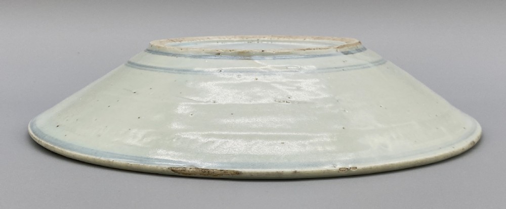 A circular 16th-century Chinese Swatow blue and white porcelain charger dish decorated with underglaze cobalt painted panels and central calligraphic motif. View XVI