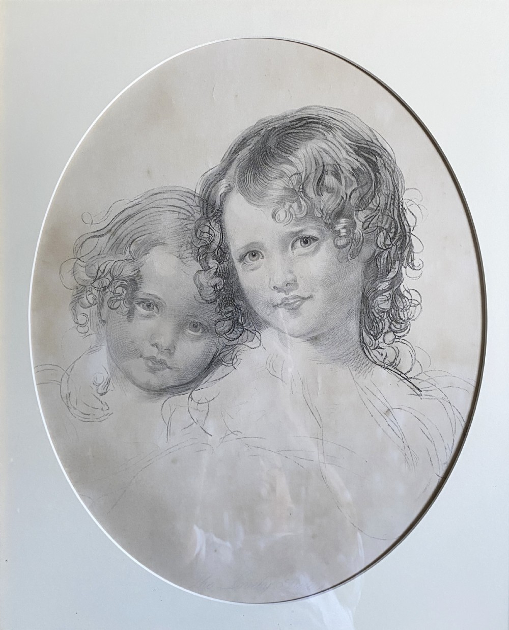 A 19th-century monochrome engraving depicting two young children set within an oval paper mount inside a moulded gold gilt frame. View II
