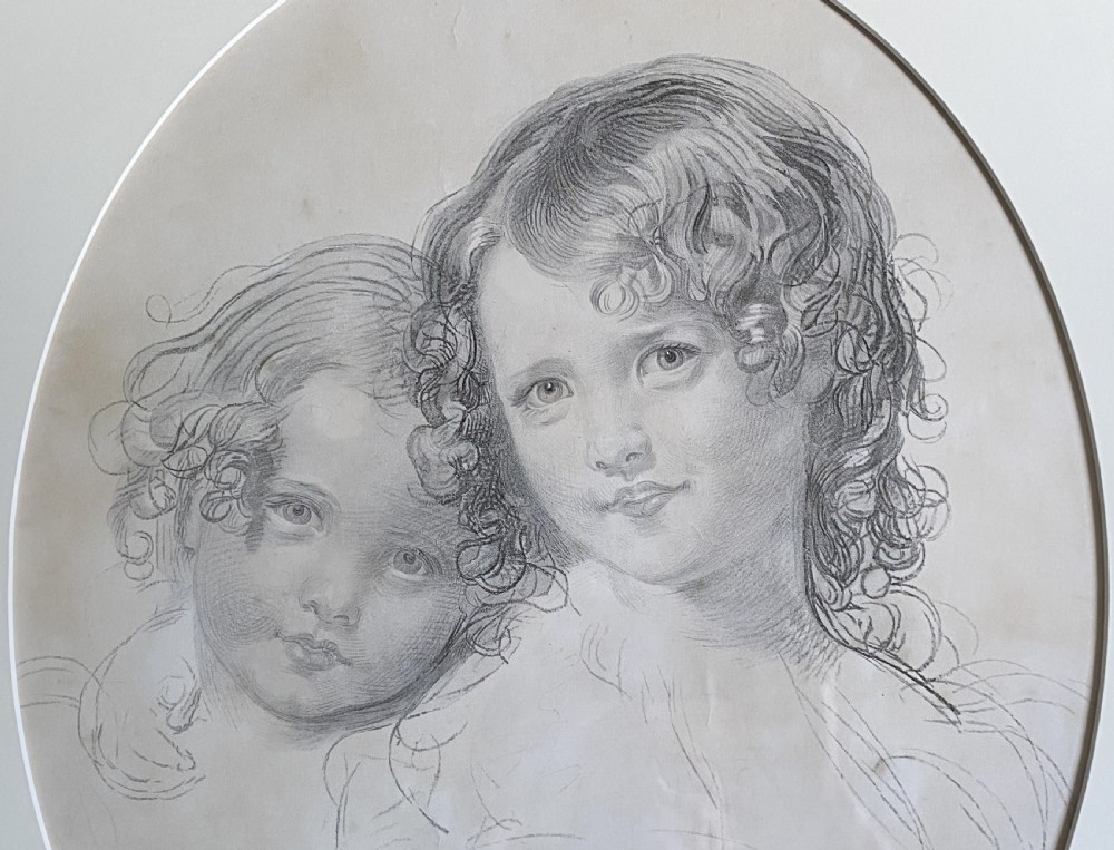 A 19th-century monochrome engraving depicting two young children set within an oval paper mount inside a moulded gold gilt frame. View V