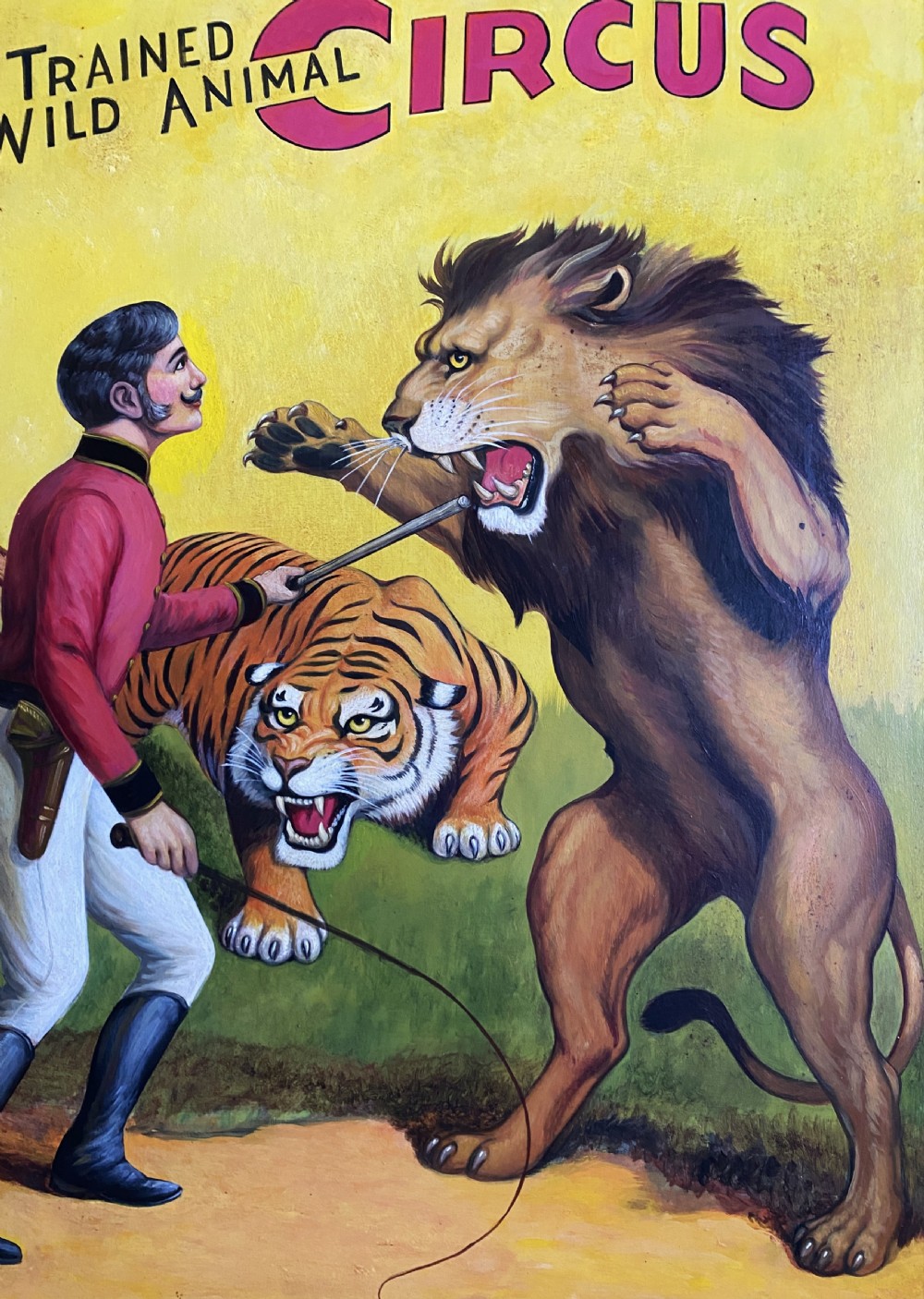 A framed mid-twentieth-century oil painting depicting a lion tamer confronting a roaring lion and a tiger against a yellow background with bold red circus lettering. View V