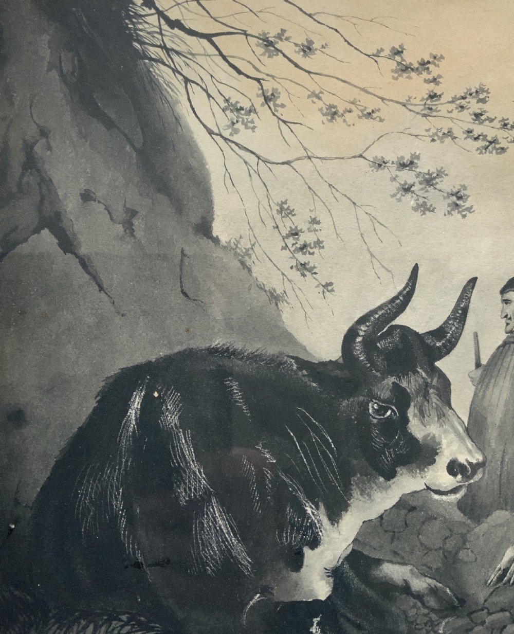 An early 19th-century monochrome pastoral artwork framed in gold, depicting a shepherd with cattle, goats, and sheep in a rocky landscape. View X