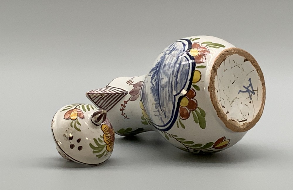 An 18th-century Dutch Delft tin-glazed ceramic coffee pot decorated with polychrome floral motifs and a central blue maritime landscape medallion. View XII