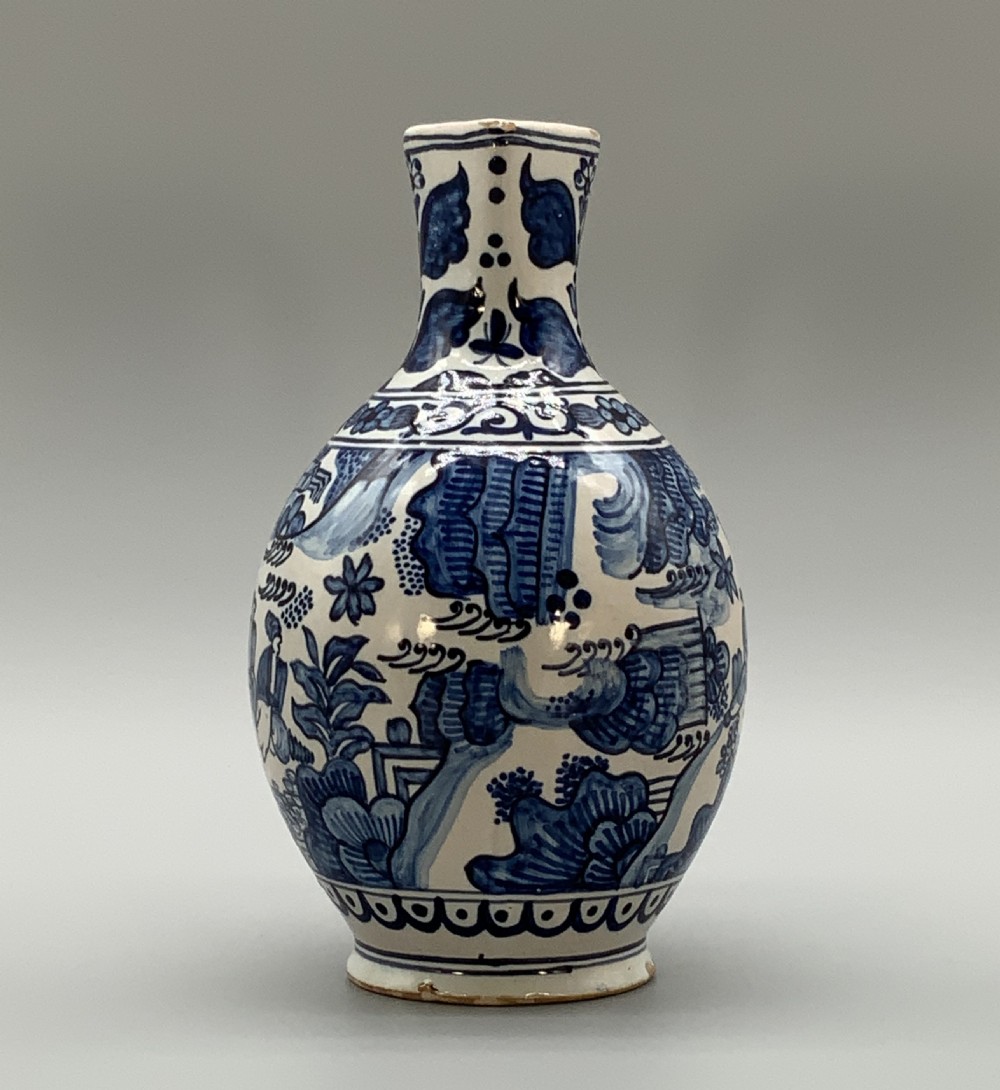 An antique Dutch Delftware ceramic jug decorated with cobalt blue hand-painted Chinoiserie figures and botanical motifs against a white tin glaze. View III