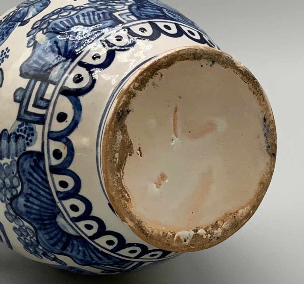 An antique Dutch Delftware ceramic jug decorated with cobalt blue hand-painted Chinoiserie figures and botanical motifs against a white tin glaze. View XV