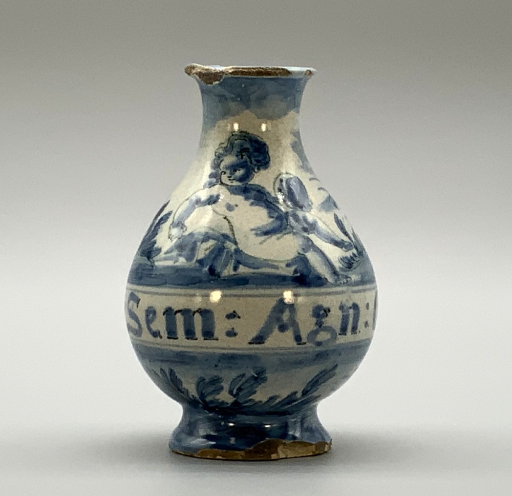 Pair of 17th-century Italian Savona majolica apothecary bottles with cobalt blue hand-painted putti and Latin inscriptions over a tin-glazed ground. View X