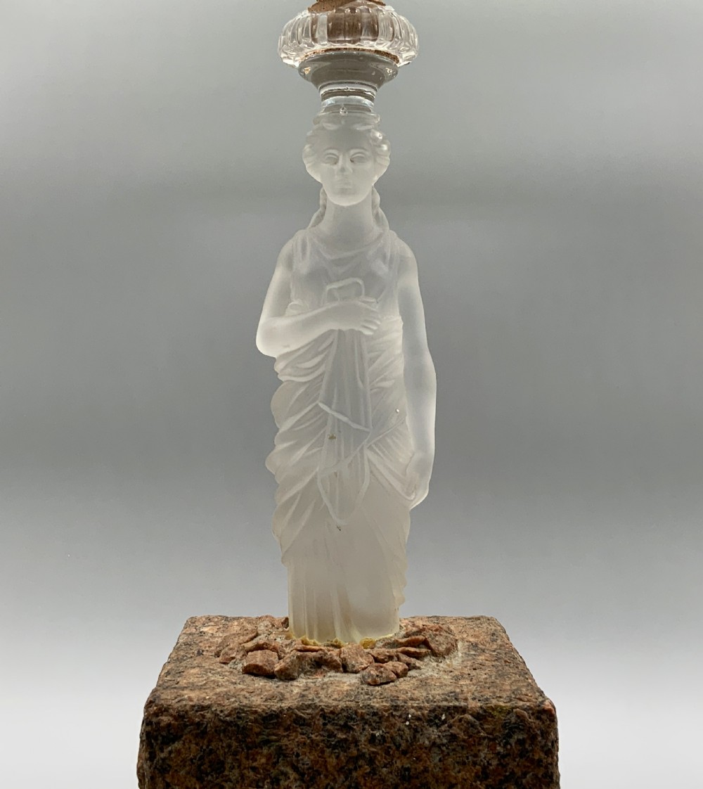 An early 20th-century French table lamp featuring a frosted glass classical figurine mounted on a square stone base, topped with a pleated blue floral lampshade. View III