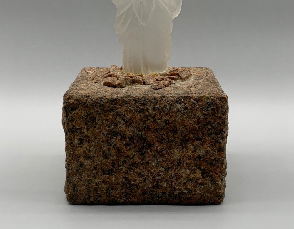 An early 20th-century French table lamp featuring a frosted glass classical figurine mounted on a square stone base, topped with a pleated blue floral lampshade. View V