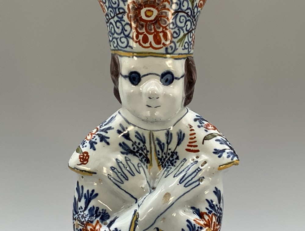 An 18th-century Dutch Delftware ceramic candlestick formed as a kneeling bishop in patterned robes and a mitre decorated with polychrome glazes. View XII