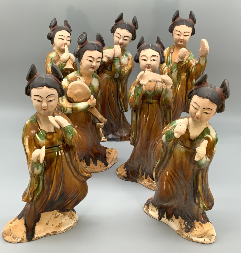 A set of seven Tang dynasty style lead-glazed earthenware figurines depicting standing female court musicians holding traditional instruments. View II