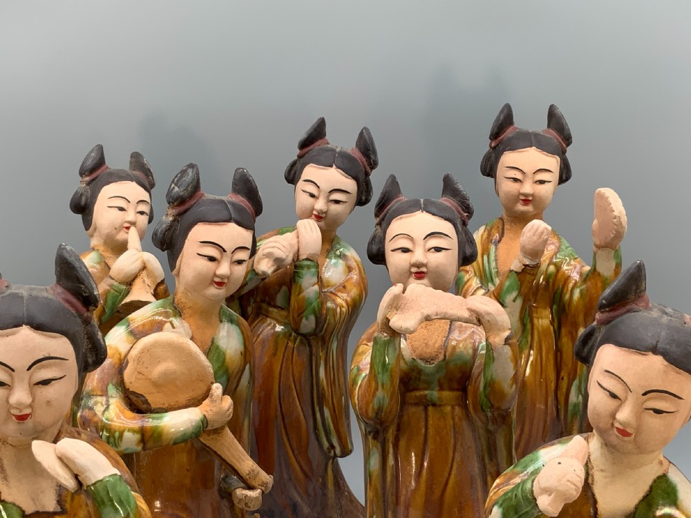 A set of seven Tang dynasty style lead-glazed earthenware figurines depicting standing female court musicians holding traditional instruments. View III