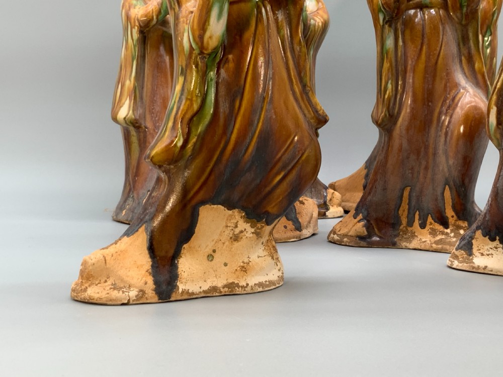 A set of seven Tang dynasty style lead-glazed earthenware figurines depicting standing female court musicians holding traditional instruments. View IV