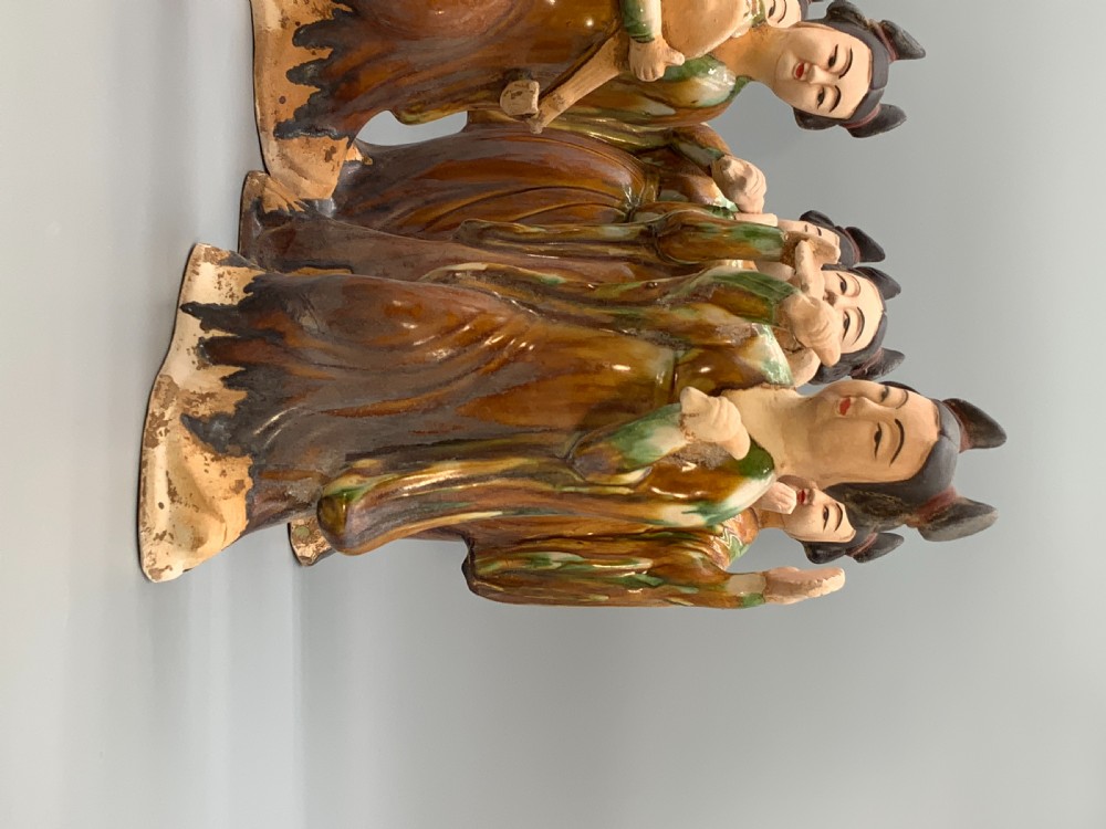 A set of seven Tang dynasty style lead-glazed earthenware figurines depicting standing female court musicians holding traditional instruments. View V