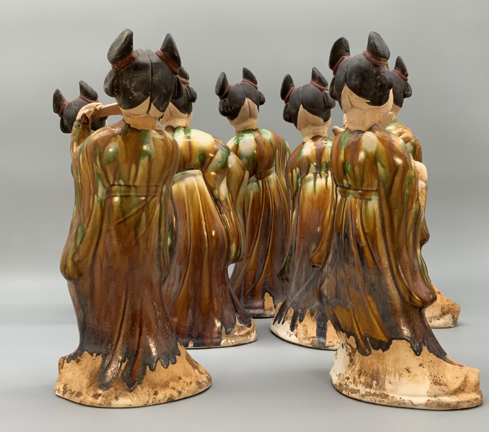A set of seven Tang dynasty style lead-glazed earthenware figurines depicting standing female court musicians holding traditional instruments. View XI