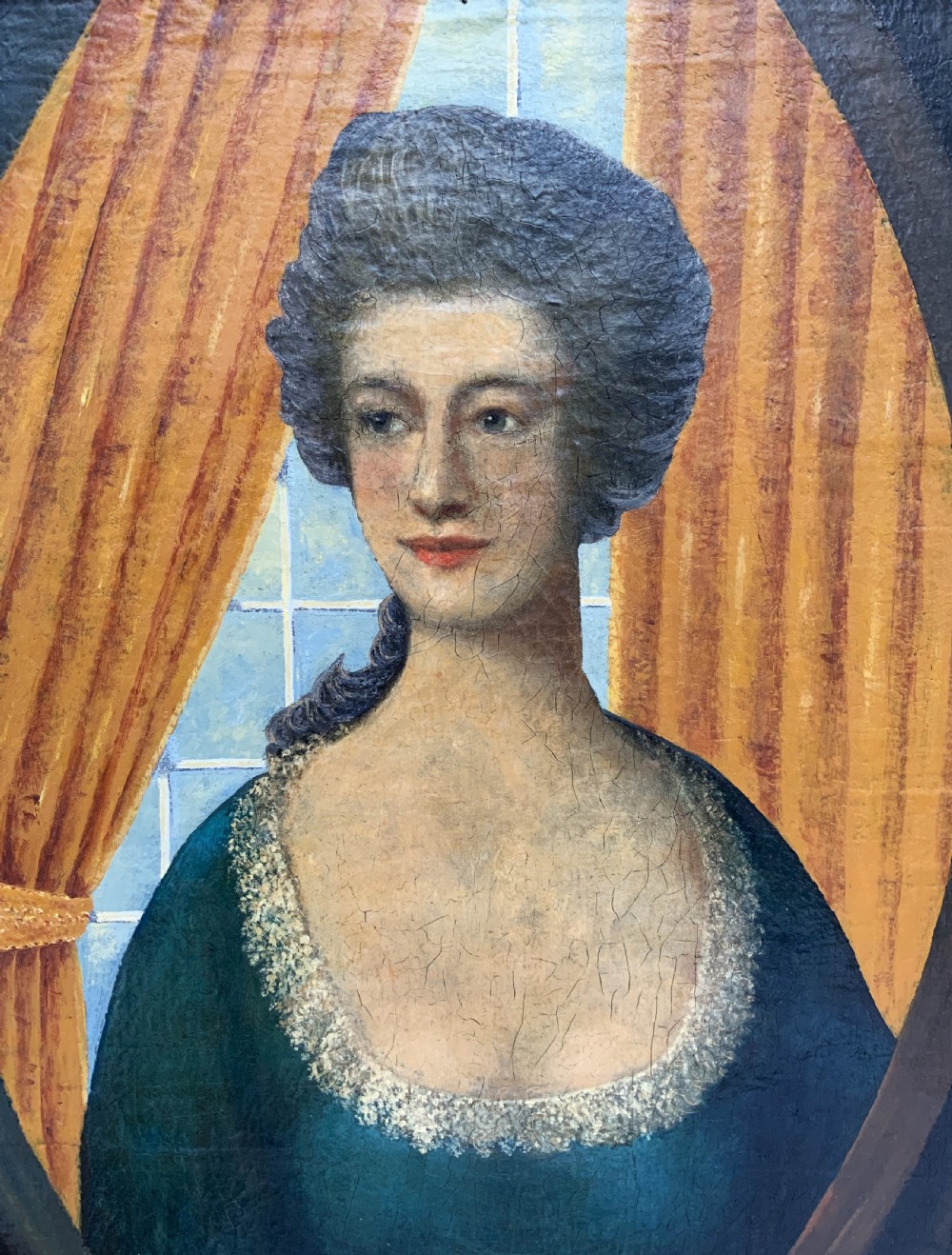 An 18th-century European oil painting depicting a woman in a teal dress set within a feigned oval and a carved gold leaf frame. View VIII